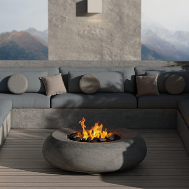 Pietra 48" Fire Bowl in Pewter finish set in a cozy patio