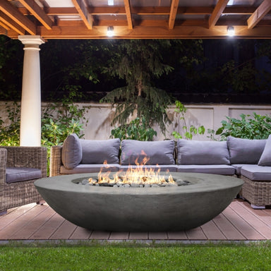 Ovale 60" Fire Bowl in Pewter finish, positioned in a serene backyard pavillon