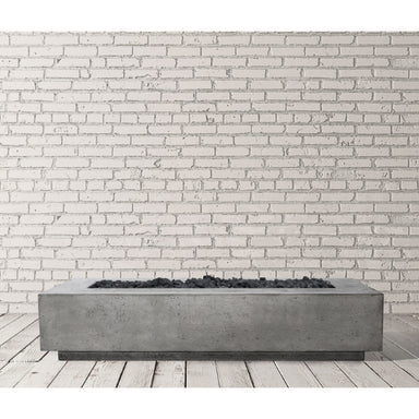 Prism Hardscapes Tavola 110 Fire Pit in Pewter finish on a spacious patio