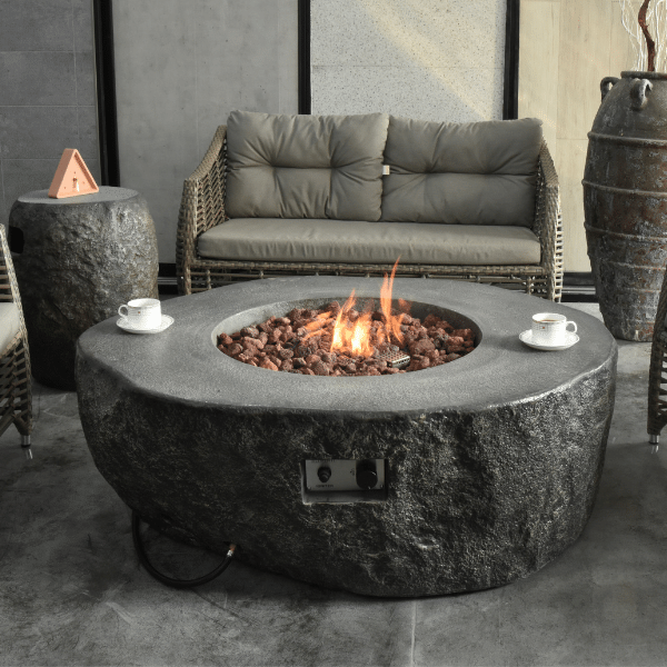 https://www.firepitsurplus.com/cdn/shop/products/Elementi-Boulder-Rock-Fire-Pit-OFG110-Actual-Photo-With-Couch-and-Tank-Cover_Png_600x600.png?v=1642635998