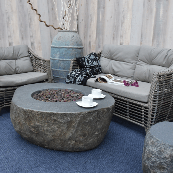 https://www.firepitsurplus.com/cdn/shop/products/Elementi-Boulder-Rock-Fire-Pit-OFG110-With-Coffee-cups-Accent-Chair-Matching-Tank-Cover-on-an-Outdoor-Set-up_Png_600x600.png?v=1642635998